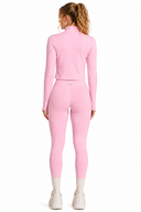 Person wearing a pink athletic outfit on a white background